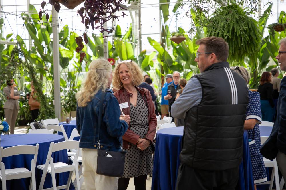 Jennifer Drake chatting with two other colleagues